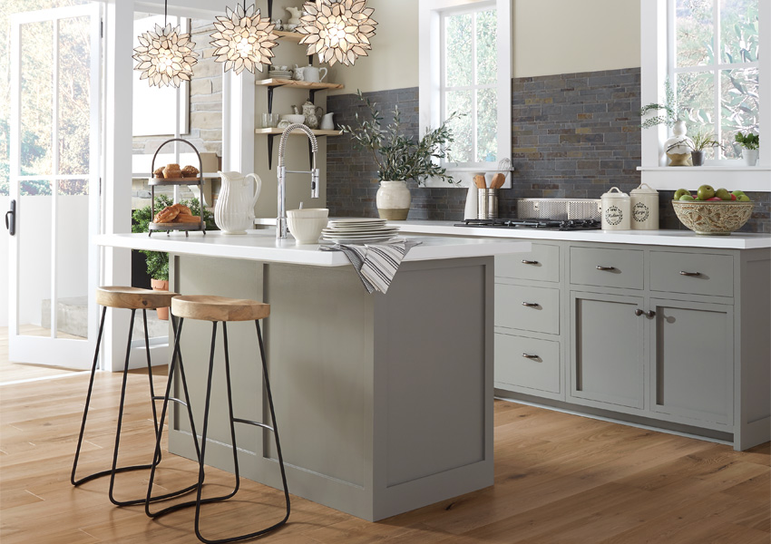 hardwood flooring in kitchen with grey cabinets and biophilic interior design elements.